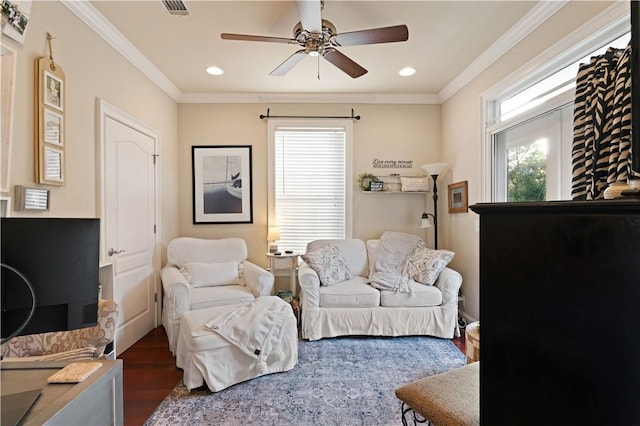 living room with crown molding, ceiling fan, and dark hardwood / wood-style floors