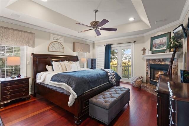 bedroom featuring ornamental molding, access to outside, a raised ceiling, ceiling fan, and dark wood-type flooring