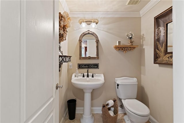 bathroom with tile patterned flooring, toilet, and ornamental molding