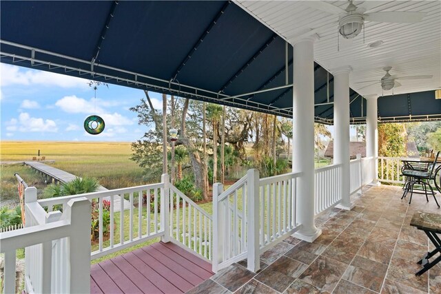 wooden deck with ceiling fan and a porch