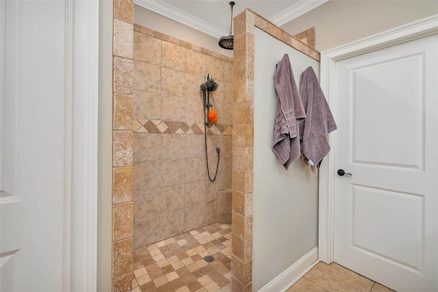 bathroom featuring tile patterned flooring, ornamental molding, and tiled shower