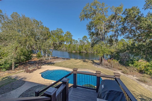 view of pool featuring a deck with water view