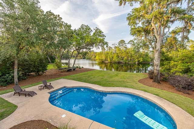 view of pool featuring a yard, a water view, and a patio