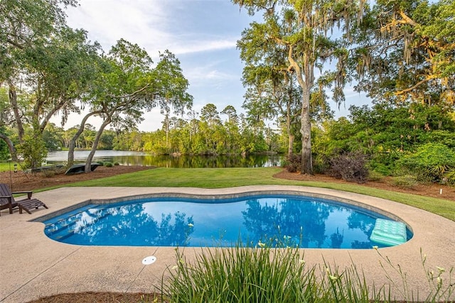 view of pool with a yard, a water view, and a patio area