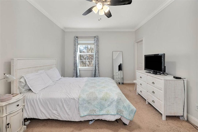 carpeted bedroom featuring ceiling fan and crown molding