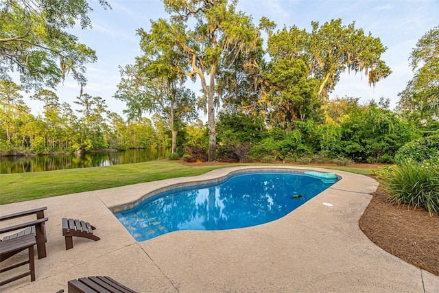 view of swimming pool featuring a water view, a patio area, and a lawn