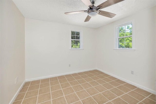 tiled spare room featuring ceiling fan and a textured ceiling