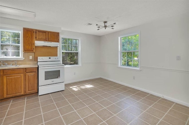 kitchen featuring sink, white electric stove, ceiling fan, light tile patterned floors, and a textured ceiling