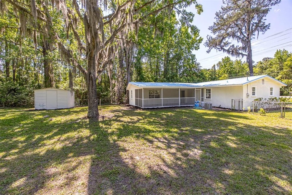 6328 New Jesup Hwy, Brunswick, GA 31523 - view of yard featuring cooling unit and a storage shed