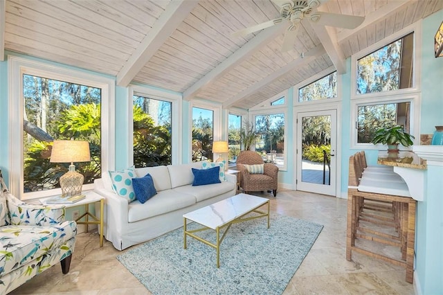 sunroom / solarium with a wealth of natural light, ceiling fan, and lofted ceiling with beams