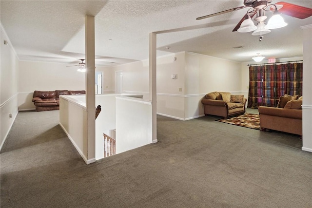 living room with carpet flooring, a textured ceiling, and ceiling fan