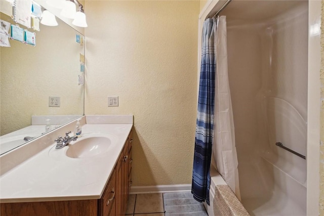 bathroom featuring tile patterned flooring, vanity, and shower / bath combo