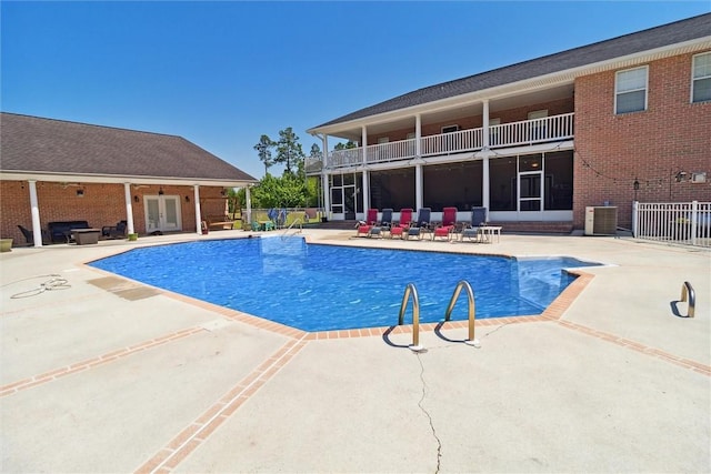 view of pool featuring central AC and a patio