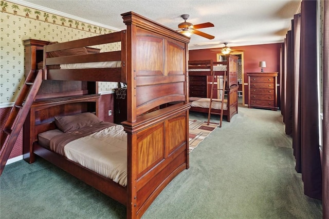 carpeted bedroom with ceiling fan, crown molding, and a textured ceiling