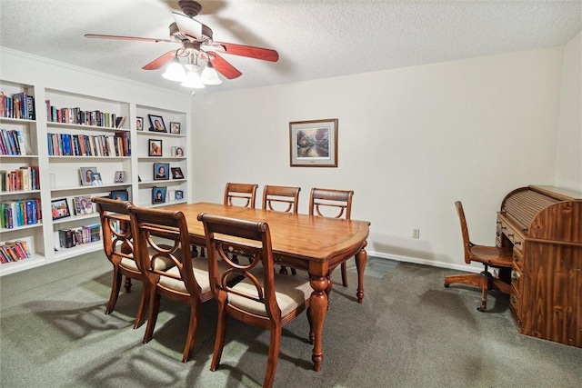 dining space featuring ceiling fan, built in features, a textured ceiling, and dark colored carpet