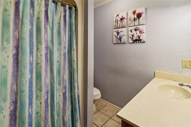 bathroom with tile patterned flooring, vanity, and toilet