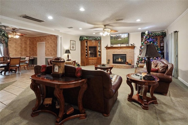 tiled living room featuring a textured ceiling, a brick fireplace, and crown molding