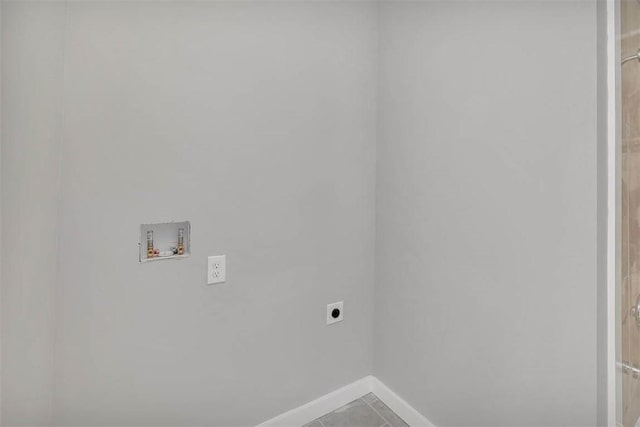 laundry area featuring tile patterned flooring, hookup for a washing machine, and hookup for an electric dryer