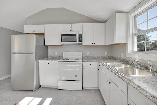 kitchen featuring sink, white cabinets, lofted ceiling, white range with electric stovetop, and stainless steel fridge