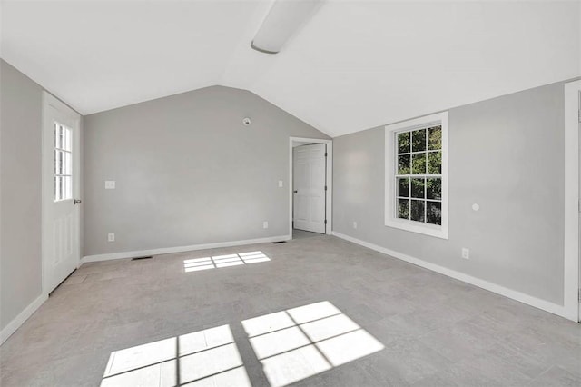 unfurnished room with vaulted ceiling and plenty of natural light