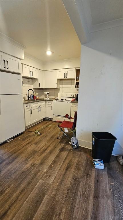 kitchen featuring white cabinetry, dark hardwood / wood-style flooring, decorative backsplash, ornamental molding, and white appliances