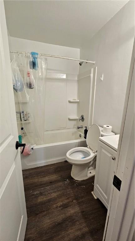 full bathroom featuring vanity, hardwood / wood-style floors, shower / bath combination with curtain, and toilet