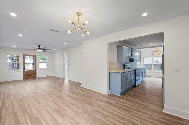 98 Atlantic Dr, Saint Simons Island, GA 31522 - unfurnished living room with light wood-style flooring, a chandelier, recessed lighting, and a ceiling fan