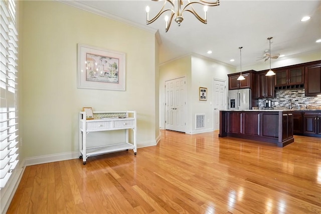 2306 Grand View Dr, Saint Simons Island, GA 31522 - kitchen with stainless steel fridge, ornamental molding, light wood-style flooring, tasteful backsplash, and baseboards