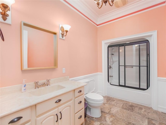 full bathroom featuring vanity, an inviting chandelier, combined bath / shower with glass door, toilet, and ornamental molding