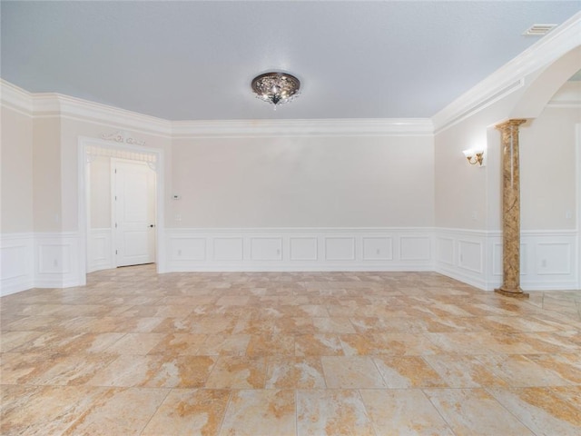 unfurnished room featuring ornamental molding and decorative columns