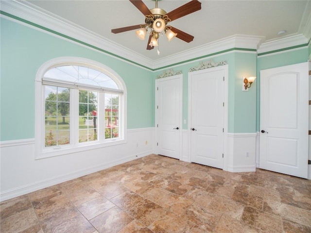 unfurnished bedroom with ceiling fan and ornamental molding