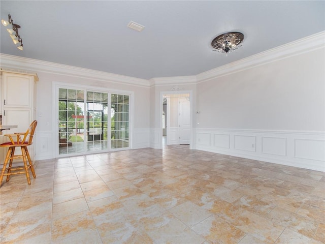 spare room featuring crown molding