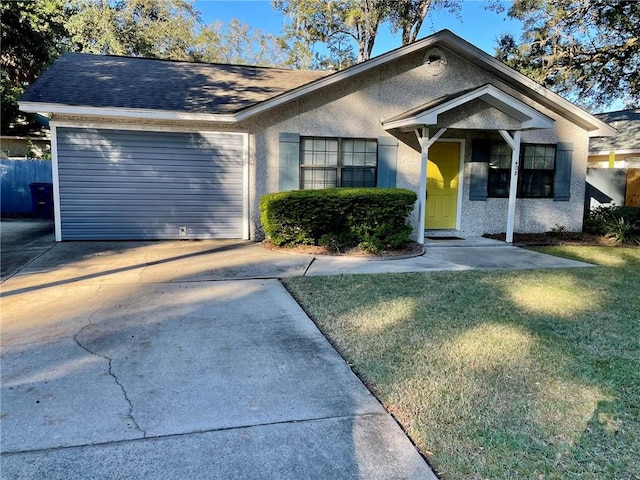 view of front of property featuring a garage and a front lawn