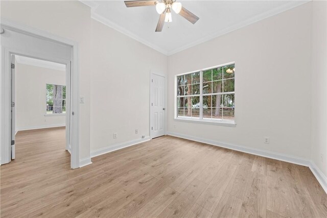 spare room with plenty of natural light, ceiling fan, ornamental molding, and light hardwood / wood-style flooring