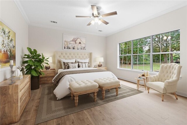 bedroom with ceiling fan, wood-type flooring, and crown molding