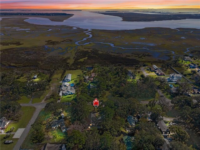 aerial view at dusk with a water view