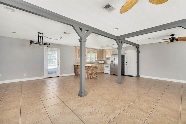 3429 US Highway 82, Brunswick, GA 31523 - unfurnished living room featuring ceiling fan, light tile patterned floors, decorative columns, baseboards, and a sink