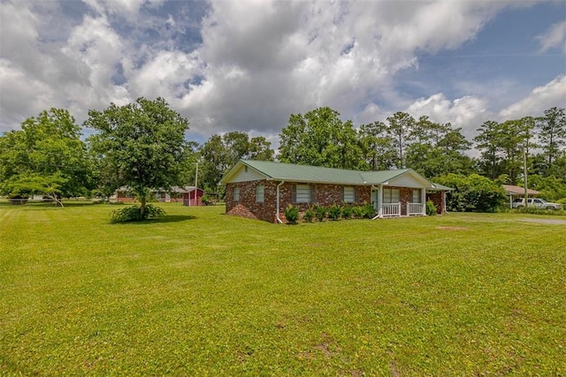 3429 US Highway 82, Brunswick, GA 31523 - view of green lawn featuring covered porch and view of wooded area