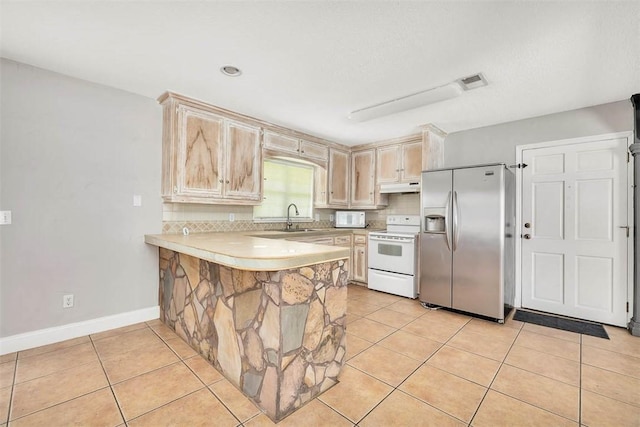 3429 US Highway 82, Brunswick, GA 31523 - kitchen with white appliances, under cabinet range hood, light countertops, a sink, and a peninsula