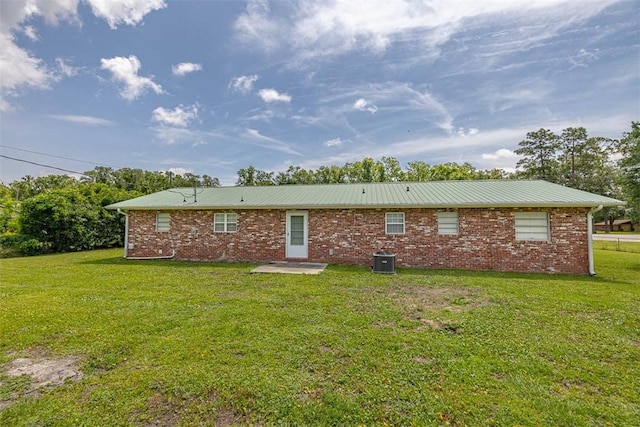 3429 US Highway 82, Brunswick, GA 31523 - rear view of house with a lawn, central AC unit, and metal roof
