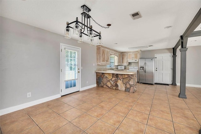 3429 US Highway 82, Brunswick, GA 31523 - kitchen featuring stainless steel fridge with ice dispenser, a peninsula, light countertops, light tile patterned flooring, and under cabinet range hood
