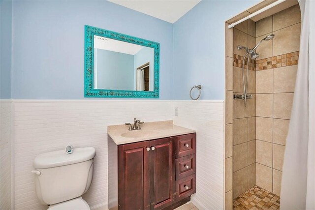 3429 US Highway 82, Brunswick, GA 31523 - bathroom featuring wainscoting, toilet, vanity, a tile shower, and tile walls