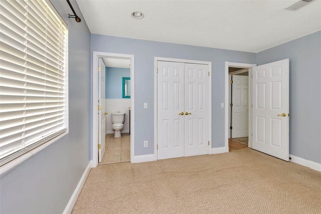 3429 US Highway 82, Brunswick, GA 31523 - unfurnished bedroom featuring carpet flooring, connected bathroom, a closet, and baseboards