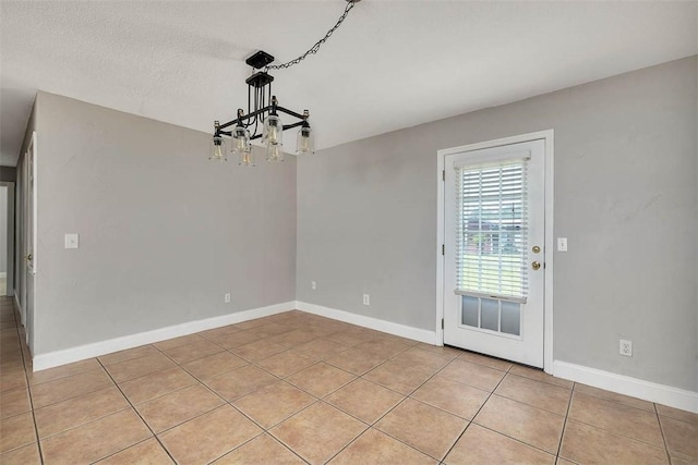 3429 US Highway 82, Brunswick, GA 31523 - unfurnished dining area featuring a chandelier, light tile patterned floors, and baseboards
