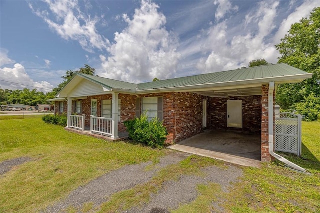 3429 US Highway 82, Brunswick, GA 31523 - view of front facade featuring asphalt driveway, a front yard, an attached carport, and brick siding