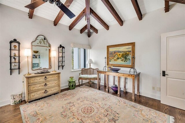 living area with lofted ceiling with beams, ceiling fan, and dark wood-type flooring