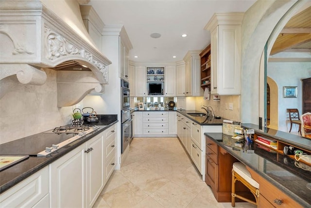 kitchen featuring white cabinetry, sink, gas cooktop, backsplash, and oven