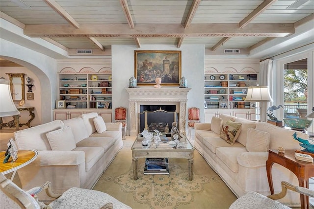 living room with beam ceiling, built in shelves, and wood ceiling