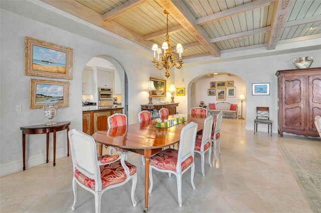 tiled dining area featuring beam ceiling, wood ceiling, and a notable chandelier