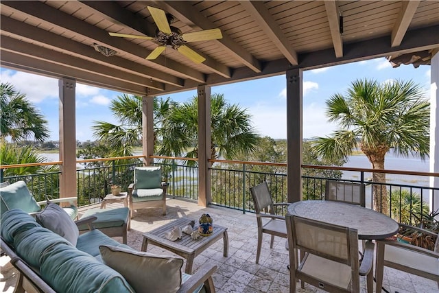 view of patio / terrace with outdoor lounge area, a water view, and ceiling fan